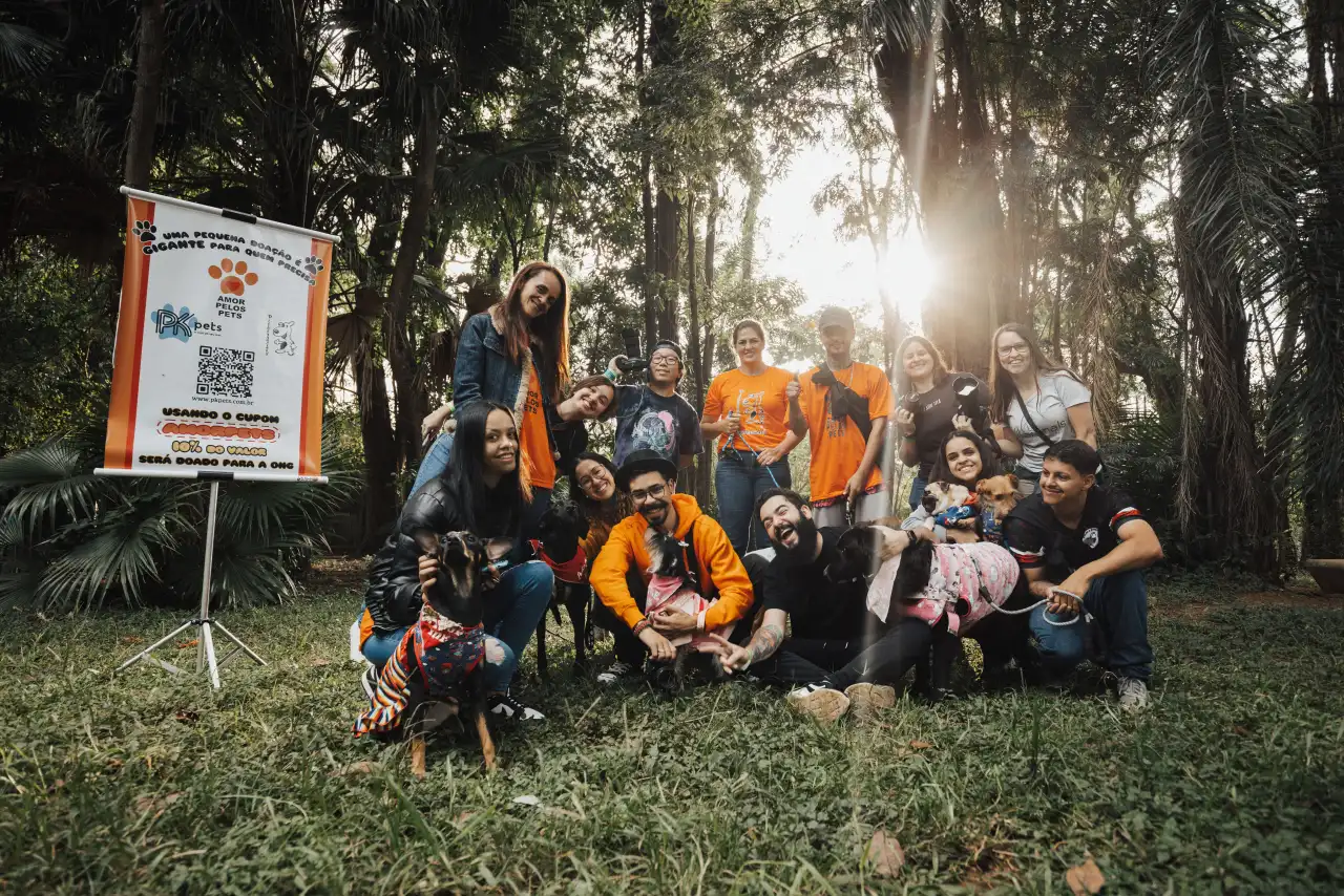 Group of people with animals at an outdoor event for a World Animal Day capybara story