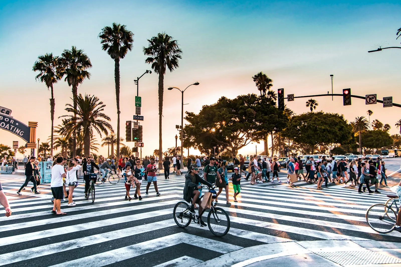 People crossing a street on Santa Monica Boulevard in California at sunset