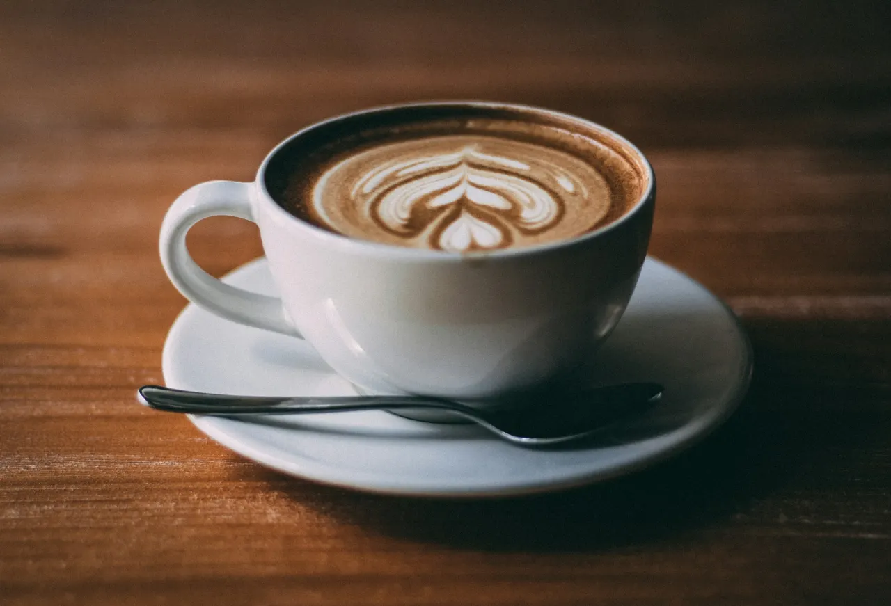 A flat white on a cafe table.