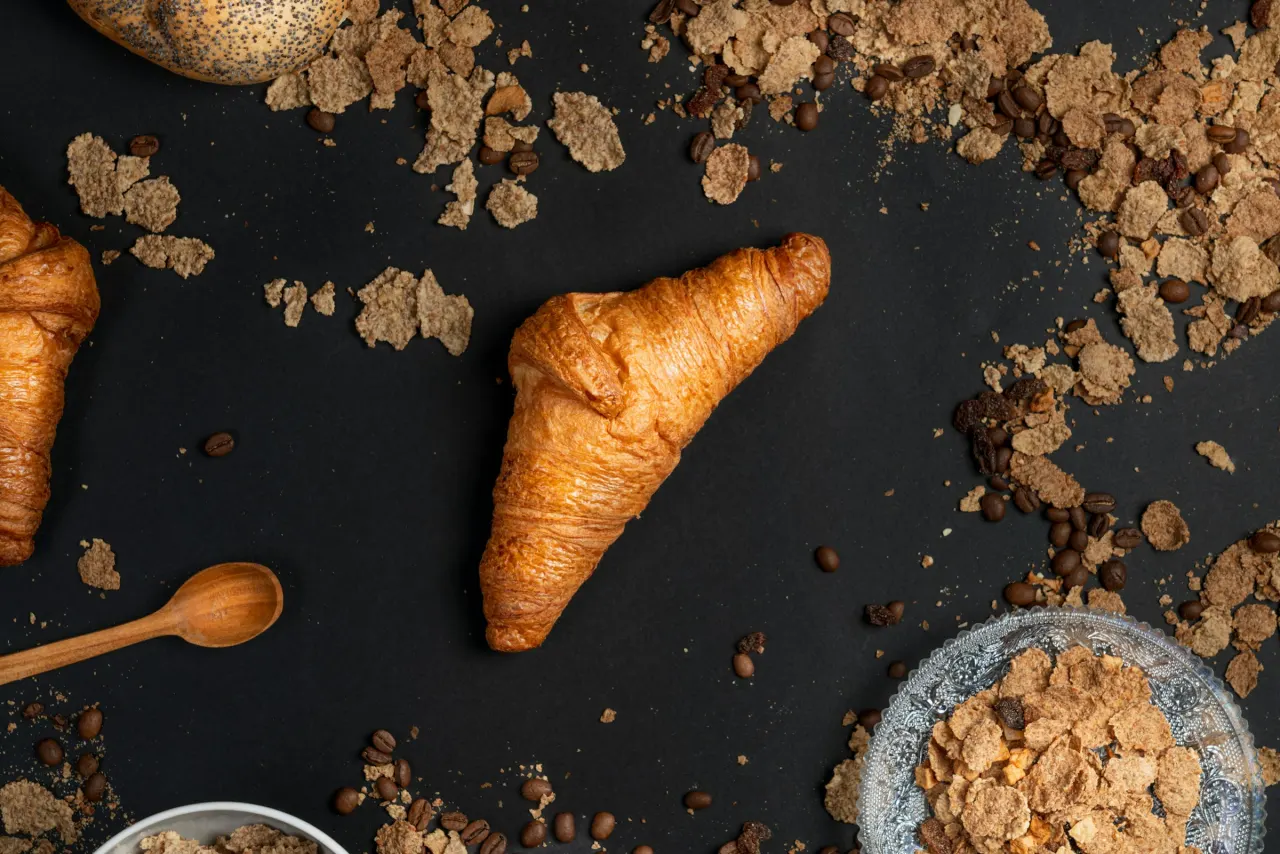 A pastry and coffee on a cafe table.