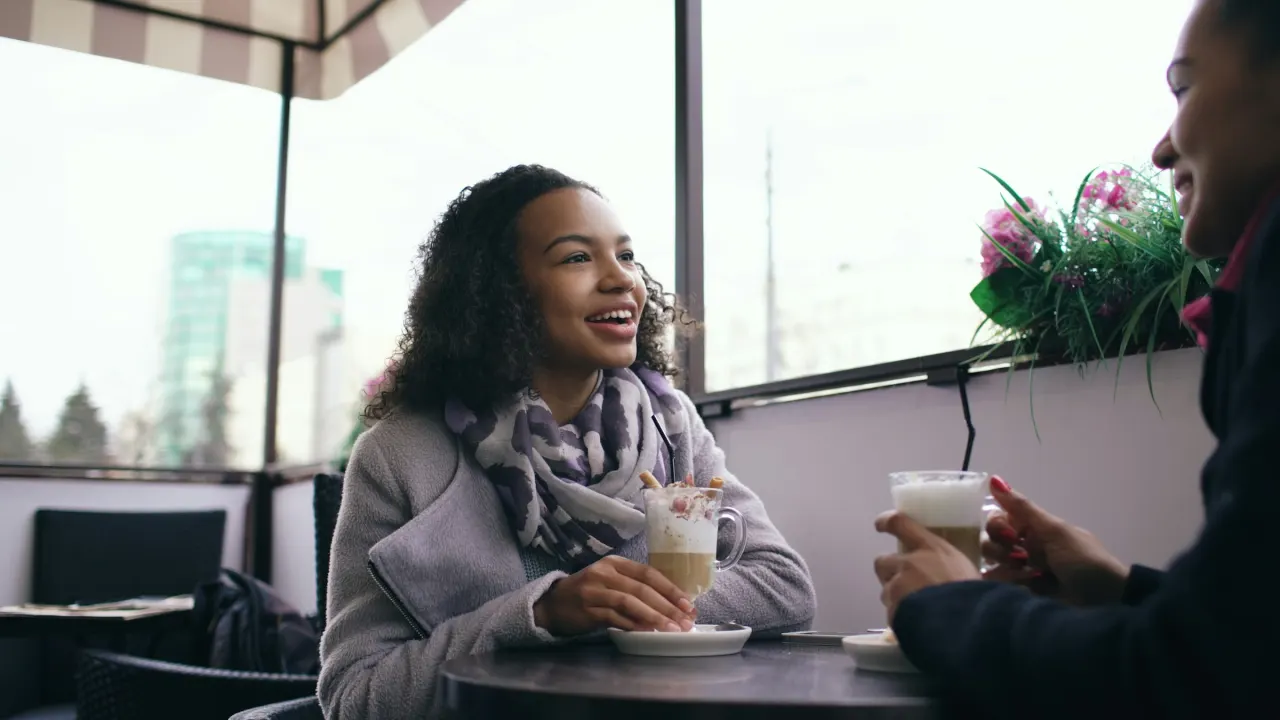 Two people at a table in a casual cafe.