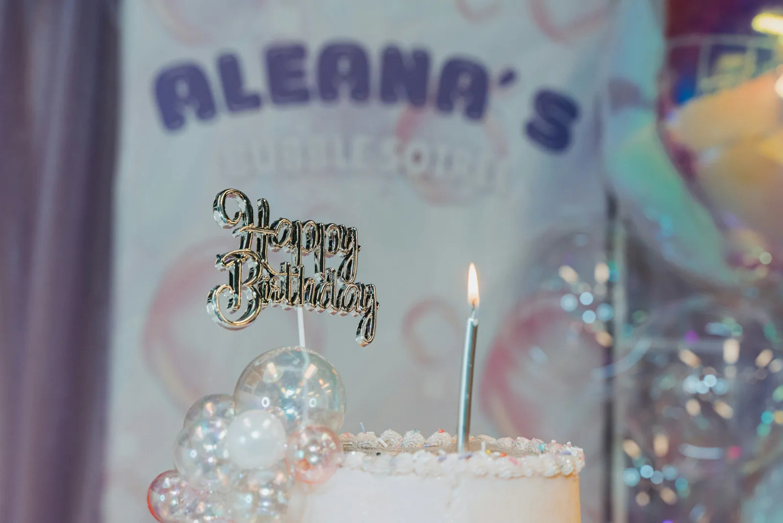 A birthday cake on a soft pastel surface, ready for someone